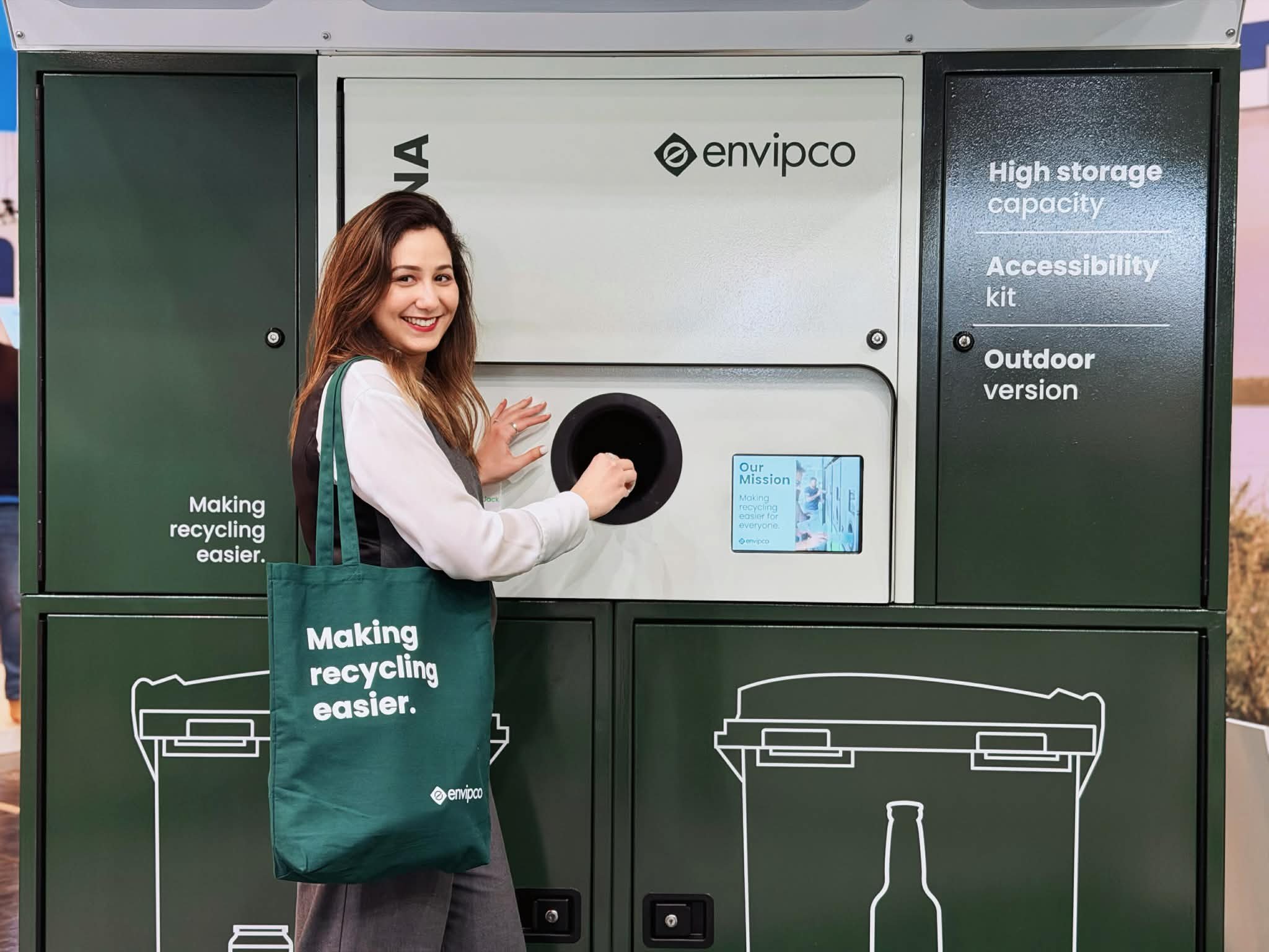 Person standing in front of a reverse vending machine (envipco magna)